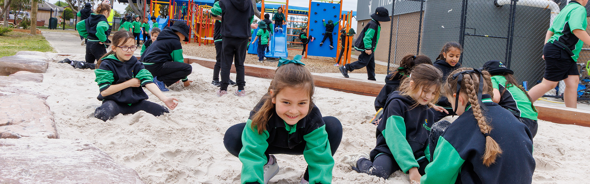 Primary School students playing in sandpit of school play area